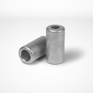 Two bolt-joint ferrules, typically utilized in combination wire rope equipment, are displayed on a white surface. One clamp stands upright with a visible hole at the top, while the other lies on its side. Both ferrules are smooth and evenly finished. © Copyright Talurit AB. All rights reserved.