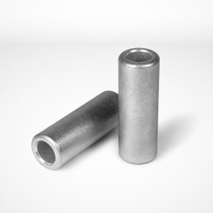 Gerro™ Combi. Two silver Joint ferrules, often used in wire rope equipment by the Talurit Group, are standing on a white background. One ferrule is upright, while the other lies horizontally next to it, both displaying a smooth metallic texture with open ends. © Copyright Talurit AB. All rights reserved.