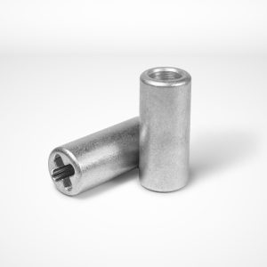 Two chain joint ferrules are displayed on a white background. One ferrule lies horizontally, with an opening suitable for a chain visible at one end. The other stands on its end, showing a flat base and a recessed slot on the top. © Copyright Talurit AB. All rights reserved.