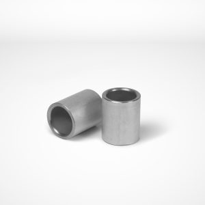Two T-joint ferrules by Talurit Group, often utilized for the mechanical splicing of combination wire rope, are positioned on a white surface. One clamp is upright, while the other is tilted sideways, leaning against it. Both clamps feature a hollow center and smooth, metallic surfaces. © Copyright Talurit AB. All rights reserved.