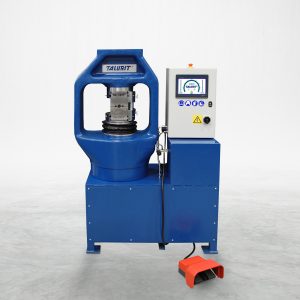 The 400T Swager, a blue hydraulic swaging machine from Talurit® renowned for their wire rope equipment, stands against a plain background. It features a control panel with a screen and buttons, along with a convenient foot pedal at its base. The machine proudly displays the 'Talurit®' brand name. © Copyright Talurit AB. All rights reserved.
