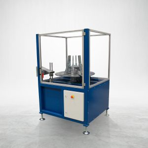 Talurit® The UL 200 - Coiling Machine features a blue metal frame with a transparent protective enclosure. Inside, you can see the mechanical components and a circular platform, making it perfect for working with ferrules. The machine stands on adjustable legs and includes a control panel equipped with red and yellow buttons. © Copyright Talurit AB. All rights reserved.