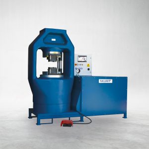 Talurit® The 2000T - Swager, a blue hydraulic press machine specifically designed for wire rope equipment, features a protective enclosure on the left side and a control panel with buttons and a display on the right. It includes a foot pedal on the floor for ease of operation. The machine is branded with "T4iWIRT," against a plain light gray background. © Copyright Talurit AB. All rights reserved.