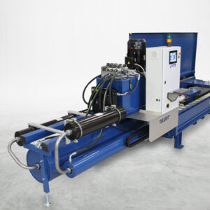 Talurit® The 300T/50T – Test Bed is a blue industrial hydraulic machine featuring a control panel, multiple hoses, and metal components, displayed on a gray concrete floor in a well-lit studio setting. © Copyright Talurit AB. All rights reserved.