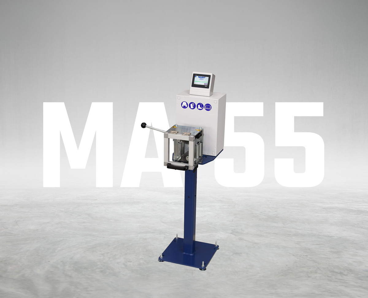 MA-55_Measuring-machine_(Web_1200px) Talurit® MA 55 Measuring Machine with a touchscreen, control buttons, and a lever, mounted on a blue stand. The text “MA 55” is displayed in large white letters in the background. © Copyright Talurit AB. All rights reserved.