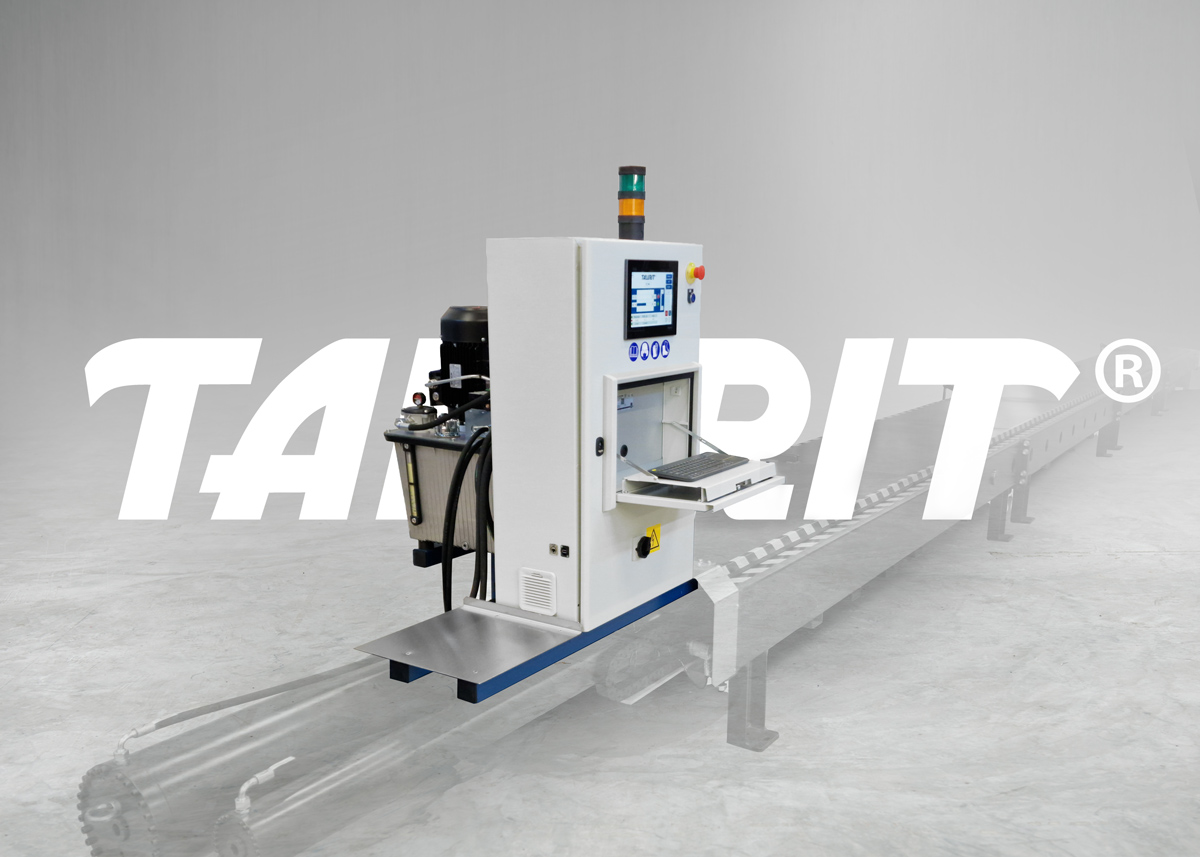Talurit®-Upgrade-Kit-Web-1200px Talurit® Retrofit Kit for test beds (testing machines) with a touchscreen and keyboard is placed in a spacious, gray industrial setting. Large, semi-transparent “TAURIT” text appears in the background. © Copyright Talurit AB. All rights reserved.